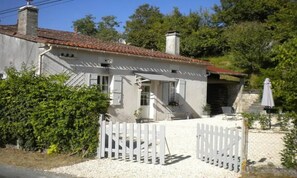 Gite garden with enclosed gates for parking and privacy.
