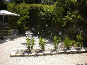 Gite garden with bistro table and chairs.