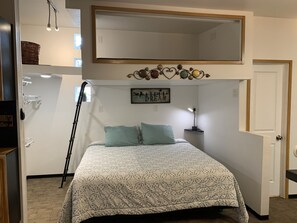 King size bed with a climb of a ladder to a Twin bed on top 