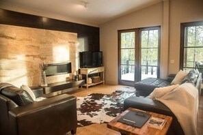 Abundance of natural light and cozy fireplace, offering a cozy haven for relaxation and warmth