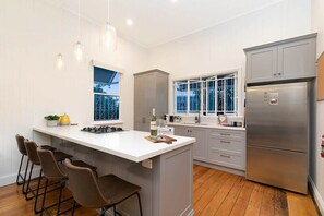 Large kitchen with dishwasher, gas cooktop and large island stone benchtop