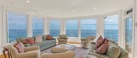 Family room with comfortable seating and expansive ocean views