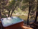 Hot tub on the rocks overlooking the river