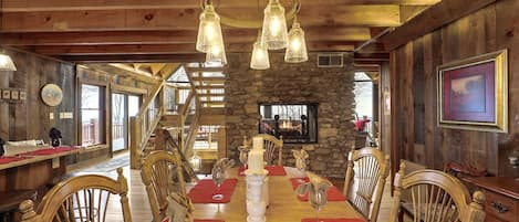 Open kitchen dining area - pretty wood beams and double sided fireplace