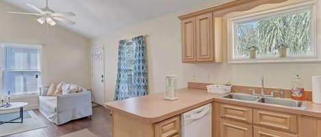 Large kitchen includes dishwasher, double sided sink with disposal, and lots of counter space