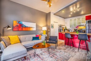 Cozy up and unwind! This stylish living room is the perfect spot to relax, watch your favorite shows, and feel right at home.