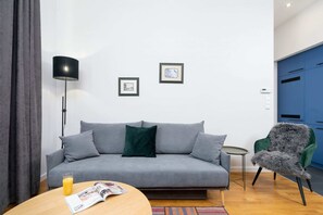 A modern living area with a gray sofa, a coffee table, and framed art on the walls, creating a comfortable atmosphere.