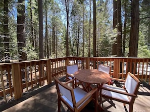 Relax on the deck with a view of the pristine pine forest.