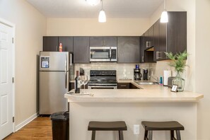 Bar stools allow plenty of seating. Between the bar stools, dining chairs, and living room sofa/chair, there's enough seating in this 1BR for up to 10 people! Perfect for having a few friends or family members over for dinner.