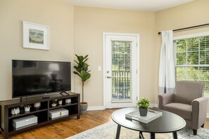 Spacious open-concept living area with comfortable furniture and 50" Roku Smart TV! Enjoy our complimentary subscription to DirecTV Stream, or use the TV to watch all your own streaming channels with the click of a button. 