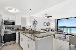 Gourmet kitchen equipped with blender, Keurig coffee machine, lots of cookware, and enough dishes and dining utensils for everyone.