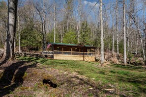 Cabin from the front yard in front of the pond.