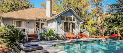 Lounge poolside and enjoy the backyard oasis