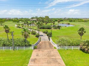 The driveway is lined with palm trees for an impressive entrance!