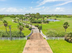 The driveway is lined with palm trees for an impressive entrance!