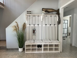 Spacious entryway with cubby bench and hooks offers great storage for shoes etc