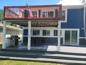 back deck with propane gas grill and table with seating for 6