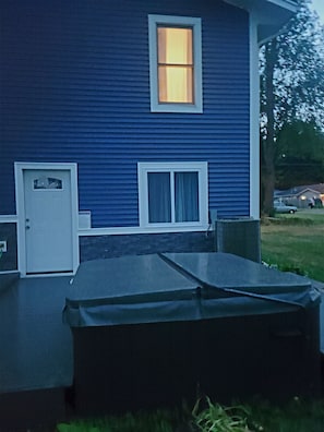 hot tub with new decking and new window from game room.