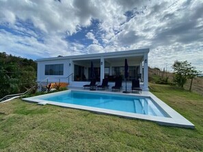 Salt water pool with covered porch . Always sunny as it faces west, over the Sea