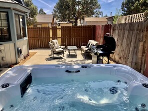 6 person hot tub with Barbecue and outdoor seating in a private backyard