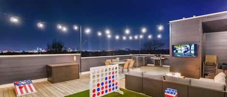 Gather on the rooftop for games or TV around the fire!