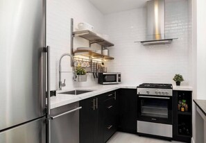 The freshly remodeled kitchen features modern appliances & Calcutta counterspace