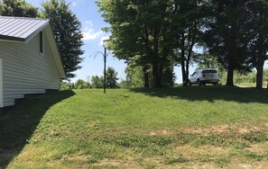 Side yard with some shade trees.