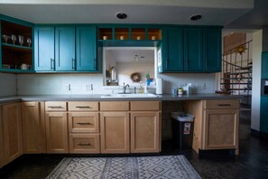 Large open kitchen with lots of color, charm and natural light. Fully stocked