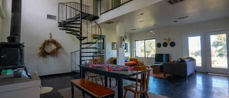 View of living spaces, loft, and stove fireplace 