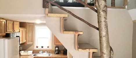 entry view of upstairs and full kitchen