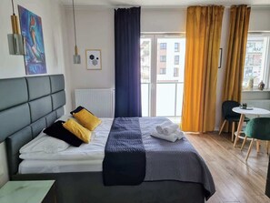 A living room with modern furnishings, yellow curtains, and warm decorative accents.