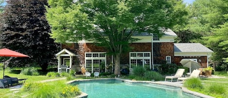 Outdoor pool lined with ornamental and native grasses.