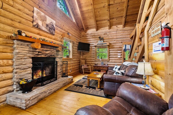 Living room w/toasty fireplace, TV w/Roku/Xfinity, leather sleeper sofa & Chair.