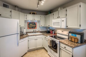 The kitchen is fully equipped with appliances and all the necessities.