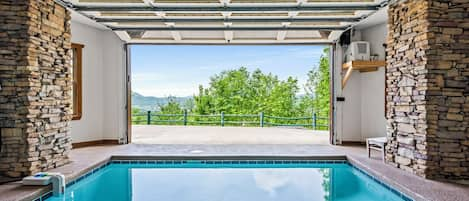 Heated indoor pool w/garage door which can be opened on warm days.