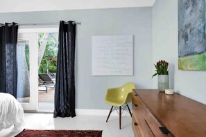 Master bedroom with French doors leading to a beautiful tropical backyard!