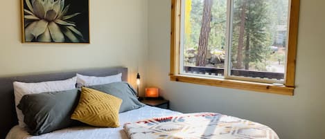 Cozy queen bed with forested view 