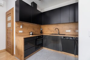 The sleek design of the kitchenette blending seamlessly with the living area.