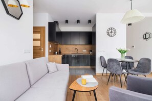 The elegant living room featuring a double sofa bed, perfect for relaxing or sleeping.