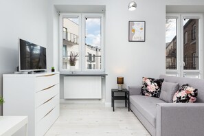 The living area's elegant color palette creates a cheerful and inviting atmosphere.