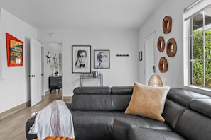 Another view of the living room that shows the entrance to the primary bedroom.