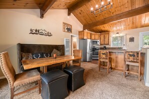 Dining Room. Vaulted Ceilings and Lake view - Bar at kitchen as well as table with cushioned chairs and a fireplace!
Patio with more, outdoor seating right outside the Dining Room.
