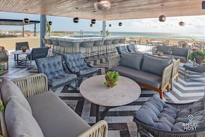 You get THIS incredible rooftop lounge! Meet fellow travelers & enjoy a drink!