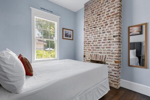 Exposed brick features and cozy textiles create a warm and welcoming ambiance.
