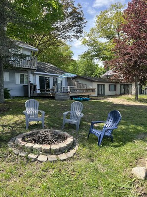 fire pit with plenty of chairs - more located in the shed.