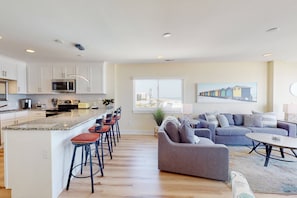 The updated kitchen features a breakfast bar with seating