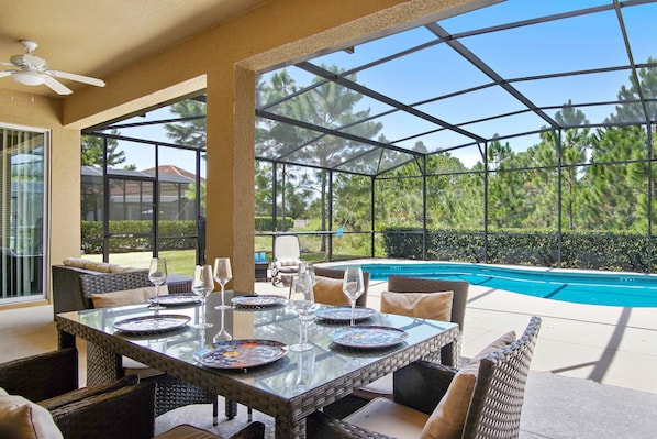 Large pool covered patio nature view.
