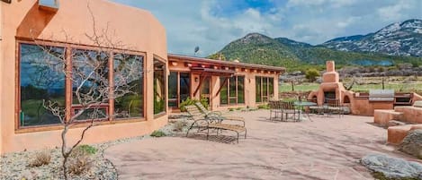 Soak up the gorgeous Taos skies and sweeping mountain views from the comfort of indoor or outdoor lounging and dining areas...complete with fireplace, grill and jumbo hot tub (not shown.)
