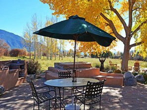 Favorite gathering spot expanded to show jumbo hot tub (center with lid down) and barbecue to left and glorious mountain views