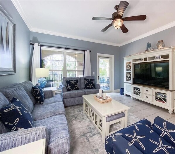 Spacious living room with seating for six an Smart 65" TV with Cable.